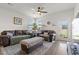 Bright living room with ceiling fan, comfortable seating, and plants near the window at 402 Toledo St., Conway, SC 29526