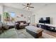 Bright living room with a ceiling fan, multiple sofas, and natural light from the windows at 402 Toledo St., Conway, SC 29526