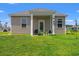 Back view of a cozy home featuring a covered patio area and a well-maintained lawn at 402 Toledo St., Conway, SC 29526