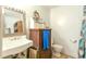 Bathroom featuring white fixtures and vanity with seashell decor on the mirror at 404 13Th Ave. S, Myrtle Beach, SC 29577