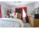 Bedroom with a bed, TV, and red curtains at 404 13Th Ave. S, Myrtle Beach, SC 29577