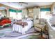 Comfortable bedroom with wood paneled walls, large windows, and ample storage cabinets at 404 13Th Ave. S, Myrtle Beach, SC 29577