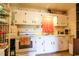 Functional kitchen with white cabinets, gas range and white appliances at 404 13Th Ave. S, Myrtle Beach, SC 29577