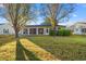 Backyard with sliding glass doors, shrubbery, and a big tree at 404 Snowy Egret Dr., Murrells Inlet, SC 29576