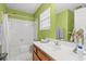 Bright bathroom with a white tiled shower/tub and a wooden vanity at 404 Snowy Egret Dr., Murrells Inlet, SC 29576