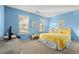 Bright bedroom featuring beachy decor, two windows, and a comfortable yellow comforter at 404 Snowy Egret Dr., Murrells Inlet, SC 29576
