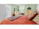 Cozy bedroom featuring light green walls, coordinated furniture, and a glimpse into the bathroom at 404 Snowy Egret Dr., Murrells Inlet, SC 29576