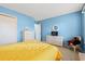 Bright bedroom with blue walls, wicker furnishings, and neutral carpeting at 404 Snowy Egret Dr., Murrells Inlet, SC 29576