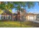 Brick home featuring a garage and a well-kept front lawn with mature trees at 404 Snowy Egret Dr., Murrells Inlet, SC 29576