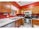 Cozy kitchen featuring wood cabinets, stainless steel appliances, and white countertops at 404 Snowy Egret Dr., Murrells Inlet, SC 29576