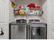 Modern laundry room with stainless steel washer and dryer with plenty of room for supplies at 404 Snowy Egret Dr., Murrells Inlet, SC 29576