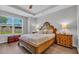 Bedroom features a large wood bed frame, hardwood floors, and tray ceiling with a large window at 4053 Taranto Loop # C, Myrtle Beach, SC 29579