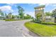 View of the stone community entrance sign with landscaping, a well-kept lawn, and attractive architecture at 4053 Taranto Loop # C, Myrtle Beach, SC 29579