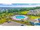 Aerial view of a large community pool surrounded by lush landscaping and ample lounge seating for residents at 4053 Taranto Loop # C, Myrtle Beach, SC 29579