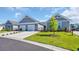 Charming home exterior with a well-manicured lawn, lush landscaping, and a two-car garage on a sunny day at 4053 Taranto Loop # C, Myrtle Beach, SC 29579