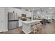 Modern kitchen with white cabinetry, stainless steel appliances, an island with stool seating and pendant lighting at 4053 Taranto Loop # C, Myrtle Beach, SC 29579