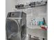 Modern laundry room featuring a state-of-the-art washing machine, overhead storage, and functional folding table at 4053 Taranto Loop # C, Myrtle Beach, SC 29579