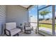 Screened-in patio with comfortable chairs, perfect for relaxing and enjoying the view at 4053 Taranto Loop # C, Myrtle Beach, SC 29579