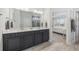 Well-lit bathroom with double vanity, neutral paint, and a view to the primary bedroom at 4449 Honir Dr., Myrtle Beach, SC 29579