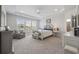 Bright primary bedroom with a ceiling fan, and large windows overlooking the yard at 4449 Honir Dr., Myrtle Beach, SC 29579