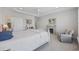 Spacious bedroom featuring a cozy sitting area, fireplace, and white-themed decor at 4449 Honir Dr., Myrtle Beach, SC 29579