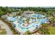 Stunning aerial view of the community pool area, showcasing multiple pools, seating, and tropical landscaping at 4449 Honir Dr., Myrtle Beach, SC 29579