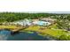 Scenic aerial view of a community pool area with multiple pools, a clubhouse, and natural pond at 4449 Honir Dr., Myrtle Beach, SC 29579