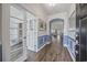Inviting entryway with blue wainscoting, hardwood floors, and decorative archway, leading to the living spaces at 4449 Honir Dr., Myrtle Beach, SC 29579