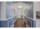 Inviting hallway featuring blue accent walls with decorative molding and beautiful hardwood flooring at 4449 Honir Dr., Myrtle Beach, SC 29579