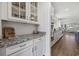 Bright kitchen with white cabinets, granite countertops, and stainless steel appliances, flowing to the living room at 4449 Honir Dr., Myrtle Beach, SC 29579
