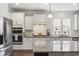 Well-equipped kitchen with stainless steel appliances, granite countertops, and a tile backsplash at 4449 Honir Dr., Myrtle Beach, SC 29579