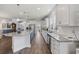 Bright kitchen with white cabinets, granite countertops, stainless steel appliances, and wood-look floors at 4449 Honir Dr., Myrtle Beach, SC 29579