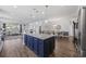 Open-concept kitchen featuring a large island with granite countertops, flowing into the living and dining areas at 4449 Honir Dr., Myrtle Beach, SC 29579