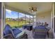 Comfortable screened-in patio featuring a plush sofa and chairs, a ceiling fan, and outdoor views at 4449 Honir Dr., Myrtle Beach, SC 29579