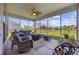 Inviting screened-in patio with stylish wicker furniture, ceiling fan, and a view of the landscaped backyard at 4449 Honir Dr., Myrtle Beach, SC 29579