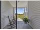 Cozy screened-in porch featuring a rocking chair and view of the neighborhood at 4449 Honir Dr., Myrtle Beach, SC 29579
