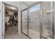 Modern tiled shower with glass doors adjacent to a walk-in closet at 4449 Honir Dr., Myrtle Beach, SC 29579
