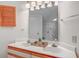 Bathroom featuring white cabinets and doors, and a double sink with decorative fixtures at 4486 Little River Inn Ln. # 2107, Little River, SC 29566