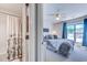Bedroom with a connecting bathroom and views of the neighborhood through its two bright windows at 4486 Little River Inn Ln. # 2107, Little River, SC 29566
