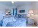 Comfortable bedroom with serene blue bedding, complemented by natural light and neutral decor for a calming retreat at 4486 Little River Inn Ln. # 2107, Little River, SC 29566
