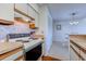 Efficient kitchen with wooden countertops, white cabinetry, and classic appliances for meal preparation at 4486 Little River Inn Ln. # 2107, Little River, SC 29566