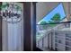 Charming porch view featuring a welcoming wreath and serene outdoor scenery through the screened door at 4486 Little River Inn Ln. # 2107, Little River, SC 29566