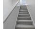 Carpeted stairs with white handrail offer a smooth transition between floors in this home at 4486 Little River Inn Ln. # 2107, Little River, SC 29566