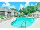 Community swimming pool surrounded by lounge chairs and lush landscaping under a sunny sky at 4486 Little River Inn Ln. # 2107, Little River, SC 29566