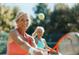 Active tennis scene with a smiling Personal hitting a ball on a sunny day at 4486 Little River Inn Ln. # 2107, Little River, SC 29566