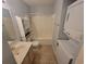 A compact bathroom with a shower, a modern sink, and a convenient washer/dryer combo at 477 White River Dr. # 32-H, Myrtle Beach, SC 29579