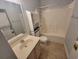 Bathroom featuring tiled floors, modern sink, shower and a stacked washer and dryer at 477 White River Dr. # 32-H, Myrtle Beach, SC 29579