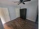 A cozy bedroom featuring wood flooring, a ceiling fan, and closet space at 477 White River Dr. # 32-H, Myrtle Beach, SC 29579