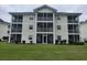 Charming condo exterior features screened balconies and well-maintained landscaping, perfect for relaxed outdoor living at 477 White River Dr. # 32-H, Myrtle Beach, SC 29579