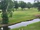 Scenic golf course view with a small stream running through it, enhancing the natural beauty of the landscape at 477 White River Dr. # 32-H, Myrtle Beach, SC 29579